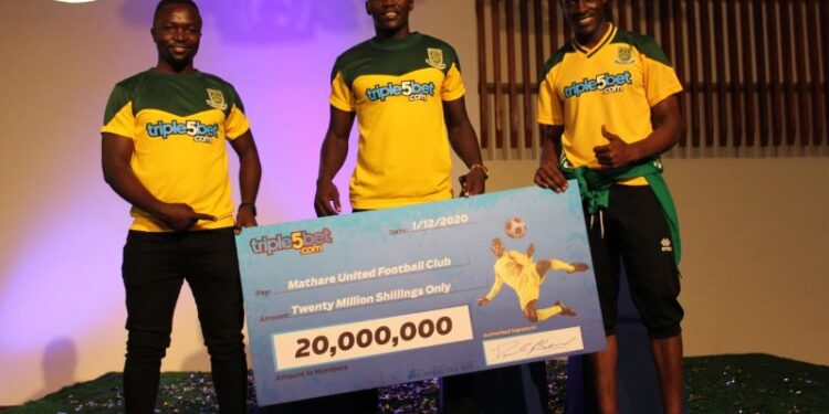 Mathare United's new signing David 'Cheche' Ochieng (centre) and his team-mates during the unveiling of a Sh20m sponsorship deal between the club and betting firm Triple5Bet at a Nairobi hotel on Tuesday. Photo/Apopo Mujema